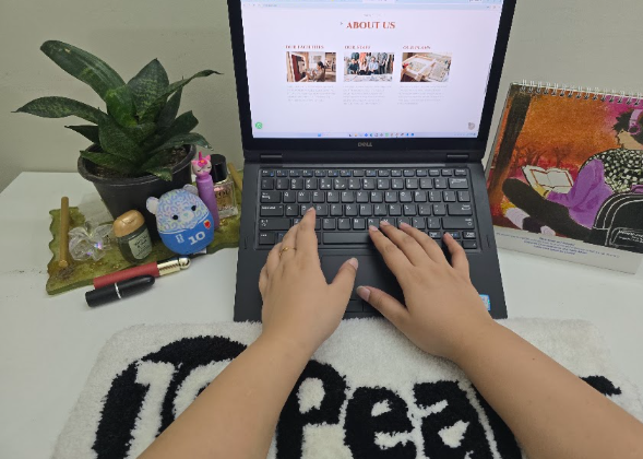 Hands typing on a laptop with a soft keyboard rug underneath