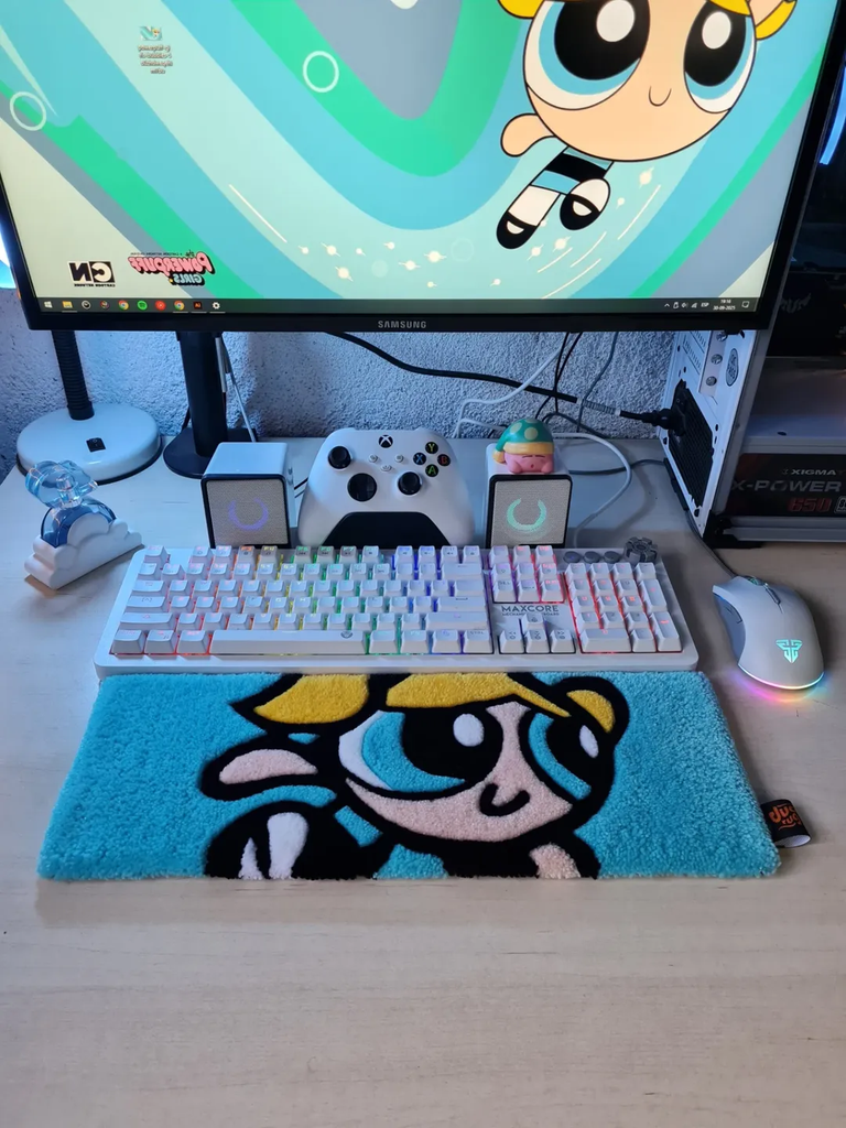 Blue keyboard rug on a gaming desk setup