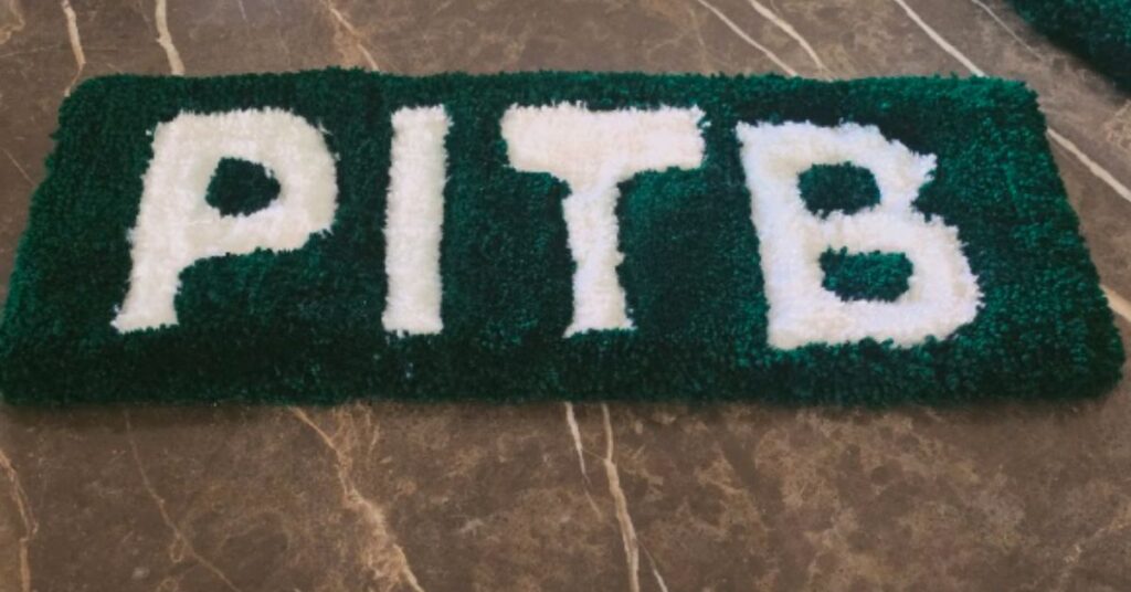 PITB custom keyboard rug with white logo on green background